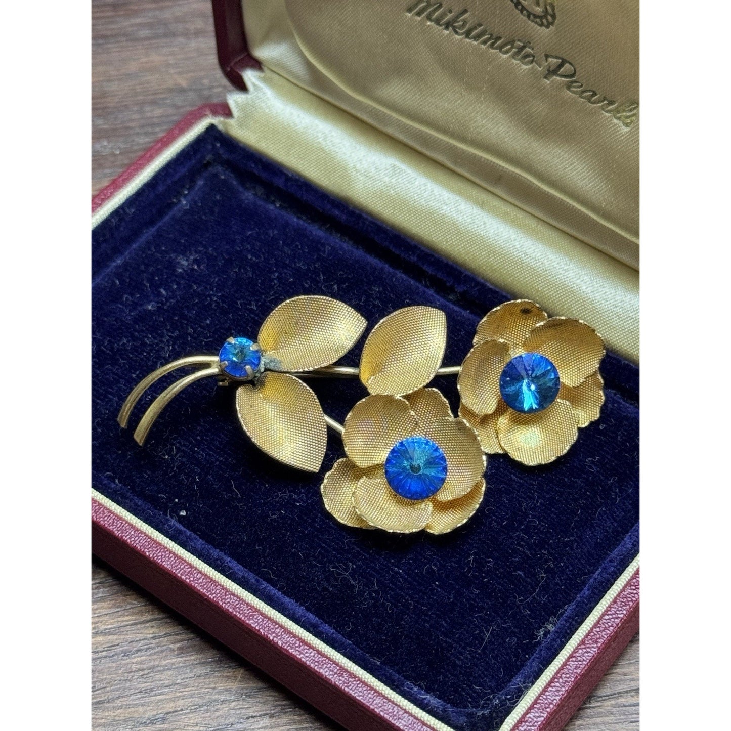 Vintage Goldtone Blue Rhinestone Flower Brooch Textured Floral Pin 2.5”