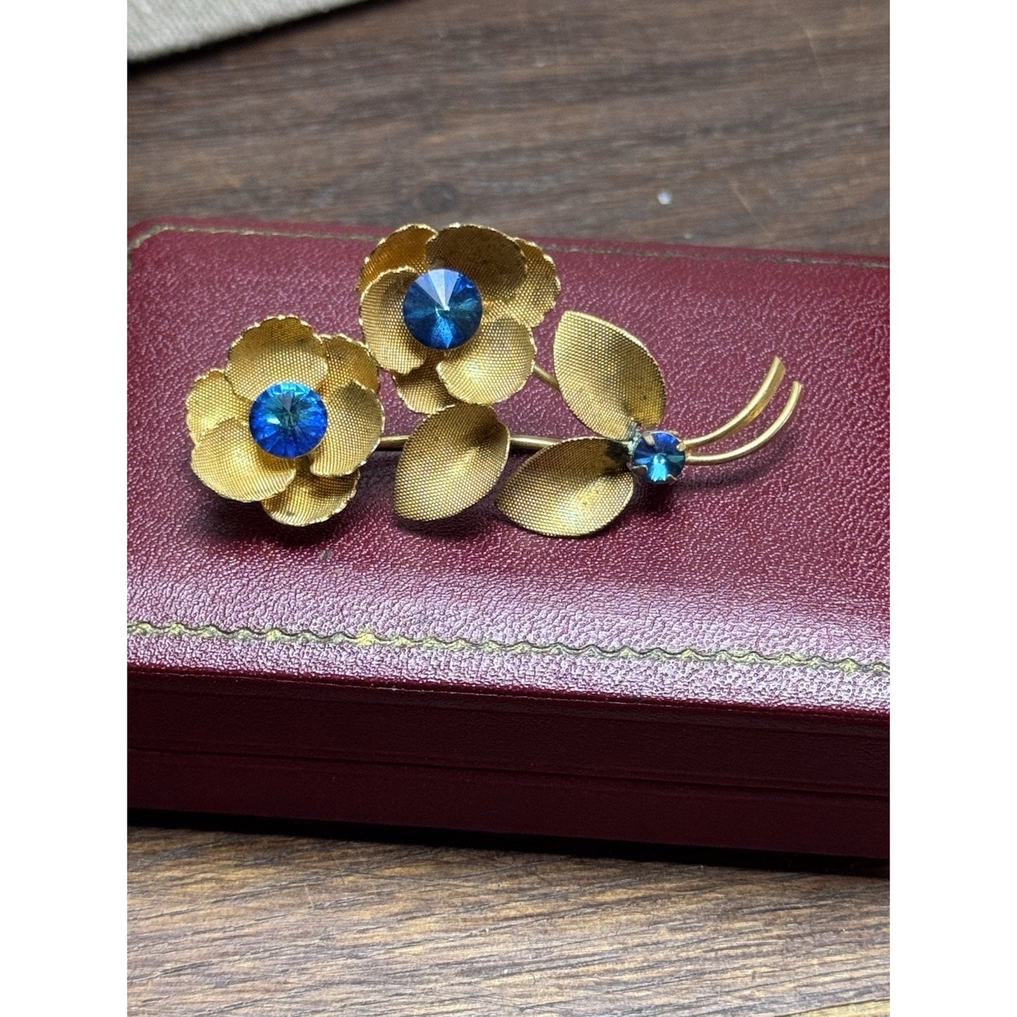 Vintage Goldtone Blue Rhinestone Flower Brooch Textured Floral Pin 2.5”